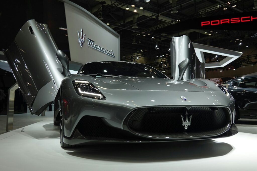 a silver sports car is on display at a car show